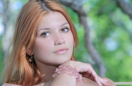 Hot redhead Violla A naked in the woods showing her shaved pussy close up