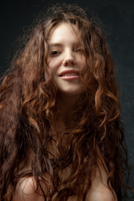 Teen girl Norma Joel wears a smile on her pretty face in over the knee hosiery