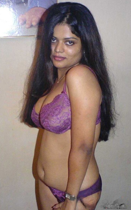 Petite Indian girl uncups big naturals after removing blue jeans