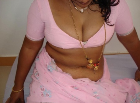 Indian babe shows her big natural tits in and out of see thru lingerie