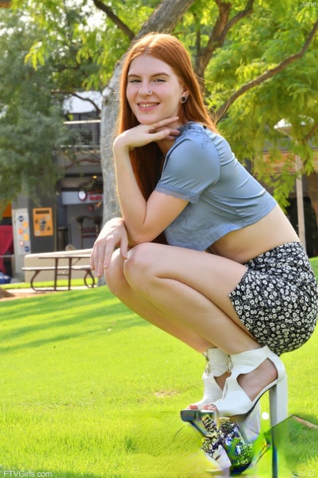 Natural redhead Jane slips cutoffs shorts aside to expose her cunt in public
