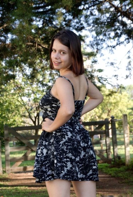 Brunette teen model Akito takes off her dress and rubs hairy twat outdoors