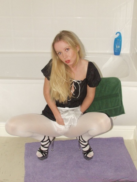 Little maid Louise rips her white pantyhose and poses in the bathroom