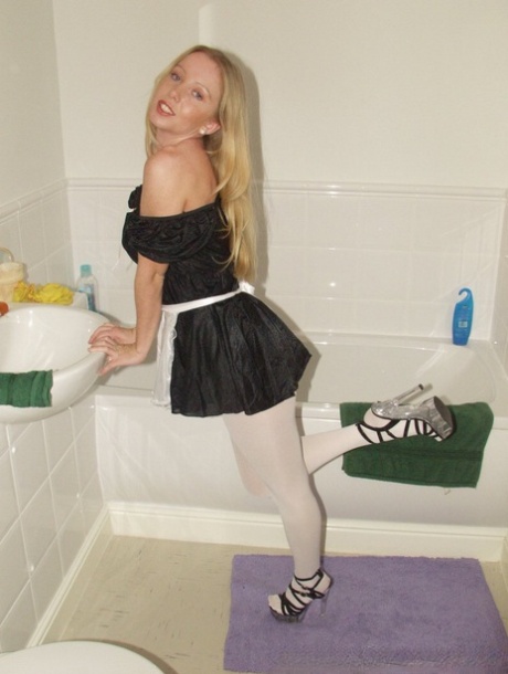 Little maid Louise rips her white pantyhose and poses in the bathroom
