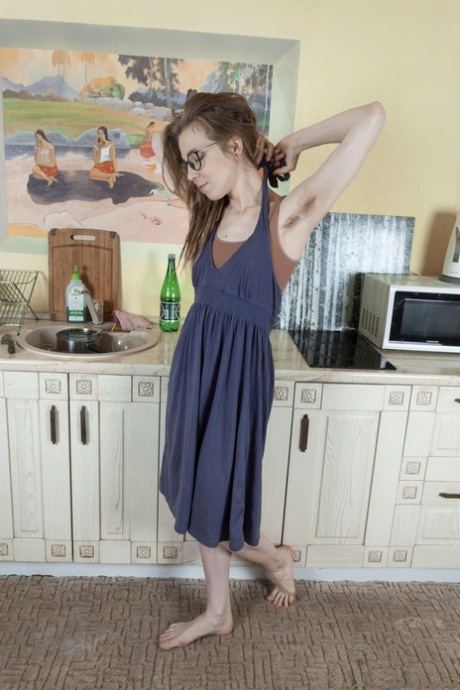 Amateur nerd Yunona exposes her hairy pussy and poses in the kitchen