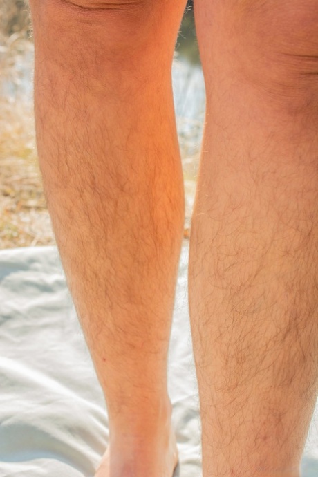 Chubby brunette Nikki Silver exposes her hairy armpits & crotch by the river