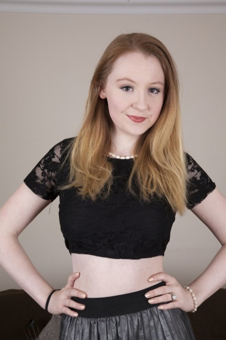 Hot redheaded teen Ruby Temptations unveils her big tits & rubs her muff