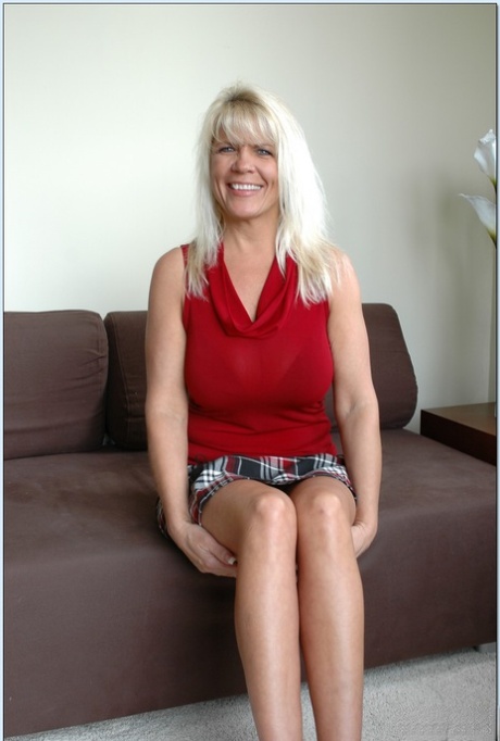 Blonde granny with amazing big tits Jerrika Michaels rides a dick on a couch